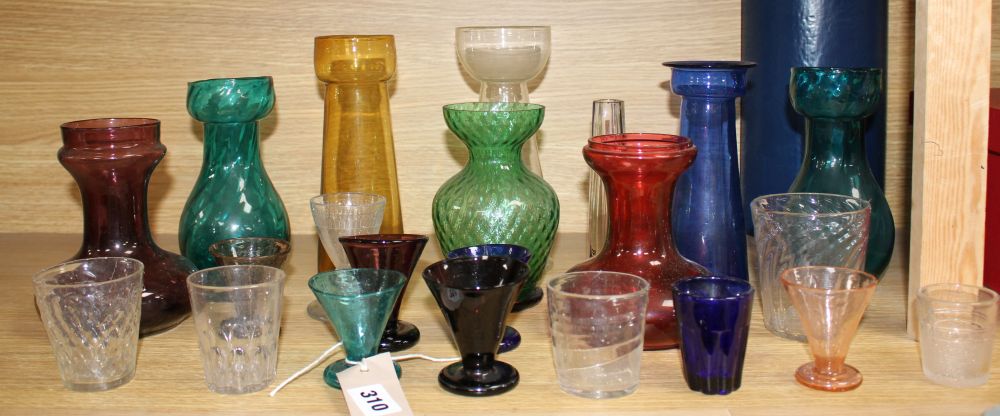 A collection of assorted coloured glassware including hyacinth vases, tallest 21cm